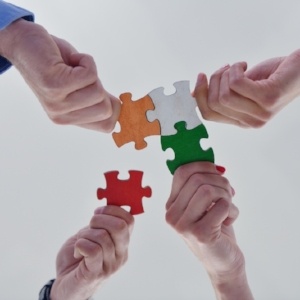 Group of business people assembling jigsaw puzzle and represent team support and help concept-051634-edited.jpeg
