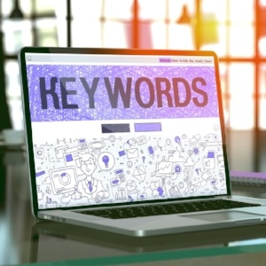 Keywords - Closeup Landing Page in Doodle Design Style on Laptop Screen. On Background of Comfortable Working Place in Modern Office. Toned, Blurred Image. 3D Render.-784186-edited.jpeg