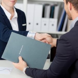 Midsection of a businessman shaking hands with a female interviewer in office-582472-edited.jpeg
